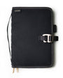 Black notebook cover with strap and buckle on a white background