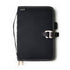 Black notebook cover with strap and buckle on a white background