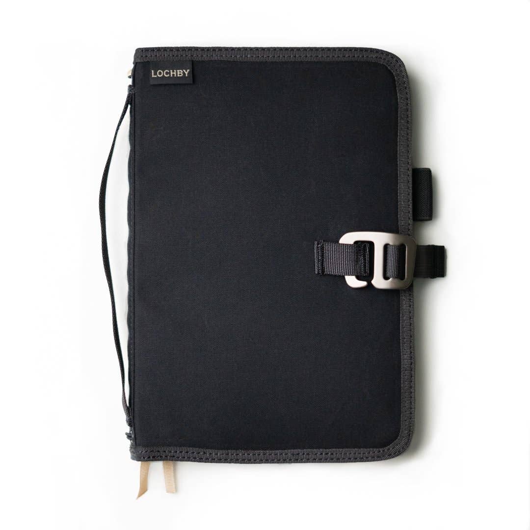 Black notebook cover with strap and buckle on a white background