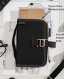 Black organizer with aircraft grade aluminium hook on a desk with notebook and glasses