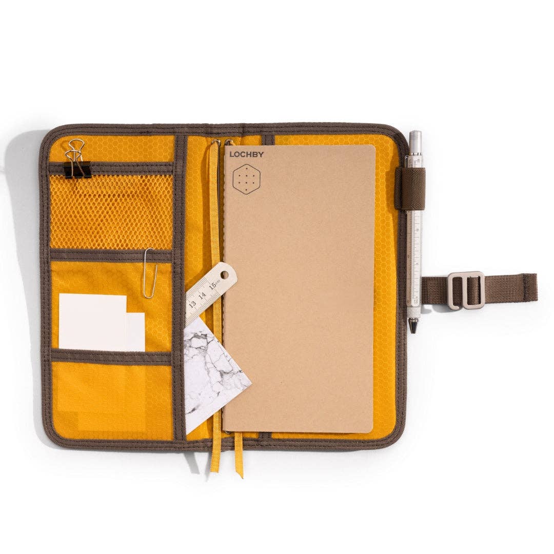 Yellow organizer with compartments and a pen on a white background