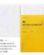 Yellow section notebook with grid pages on a white background