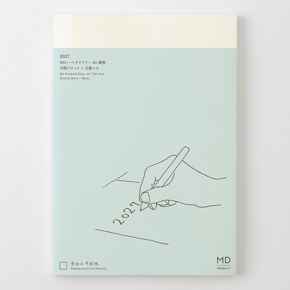 A notebook or planner cover shown flat against a light gray background. The cover is pale mint green with a cream-colored top section and a simple line drawing of a hand writing '2021'.