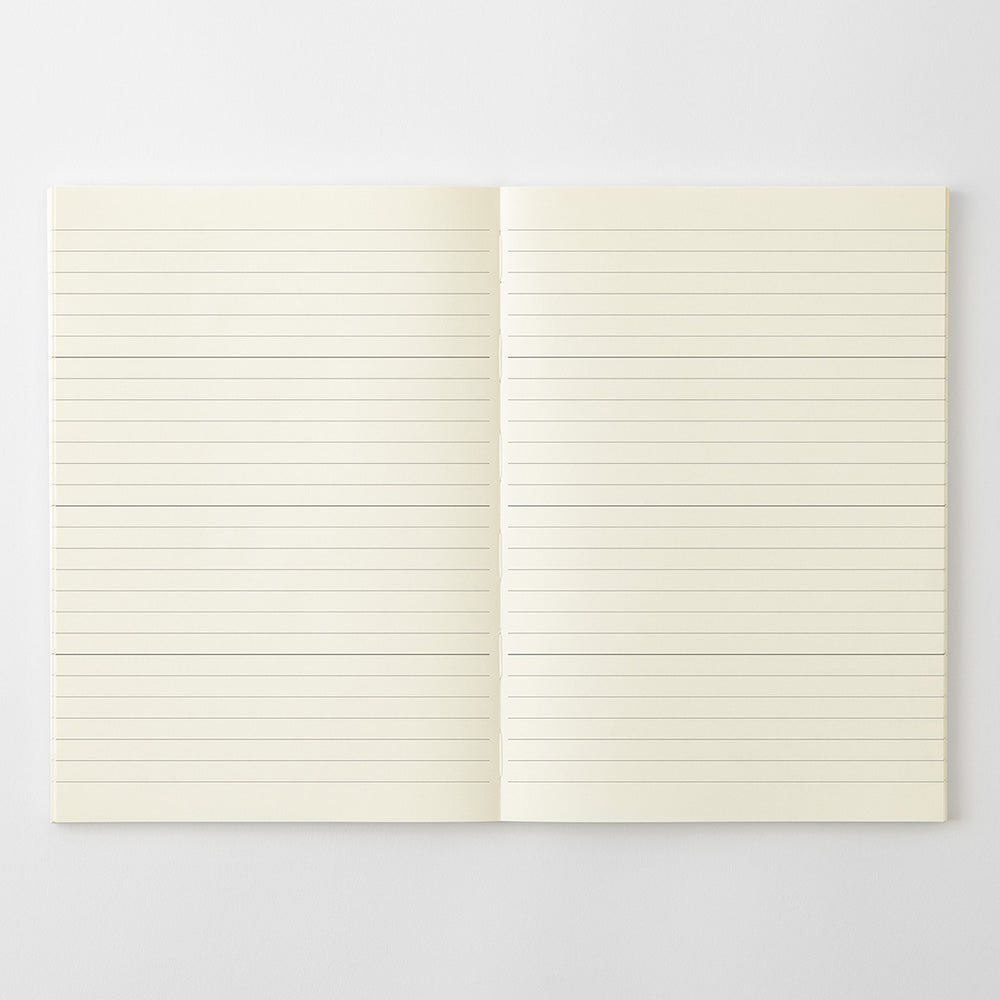 An open notebook with blank, lined cream-colored pages, displayed flat against a light gray background.