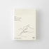 A cream-colored daily planner notebook with minimalist black line art and Japanese text, shown in its packaging against a light gray background.