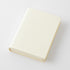 A cream-colored hardcover notebook or journal with a textured cover, shown at an angle on a clean white background.