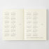 An open cream-colored book or planner showing printed calendar pages for 2027 and 2018 in gray text, photographed against a light gray background.