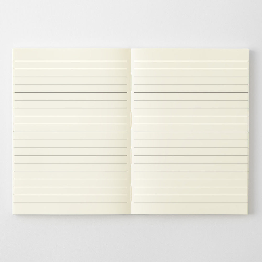 An open notebook with cream-colored lined pages, displayed flat against a light gray background.