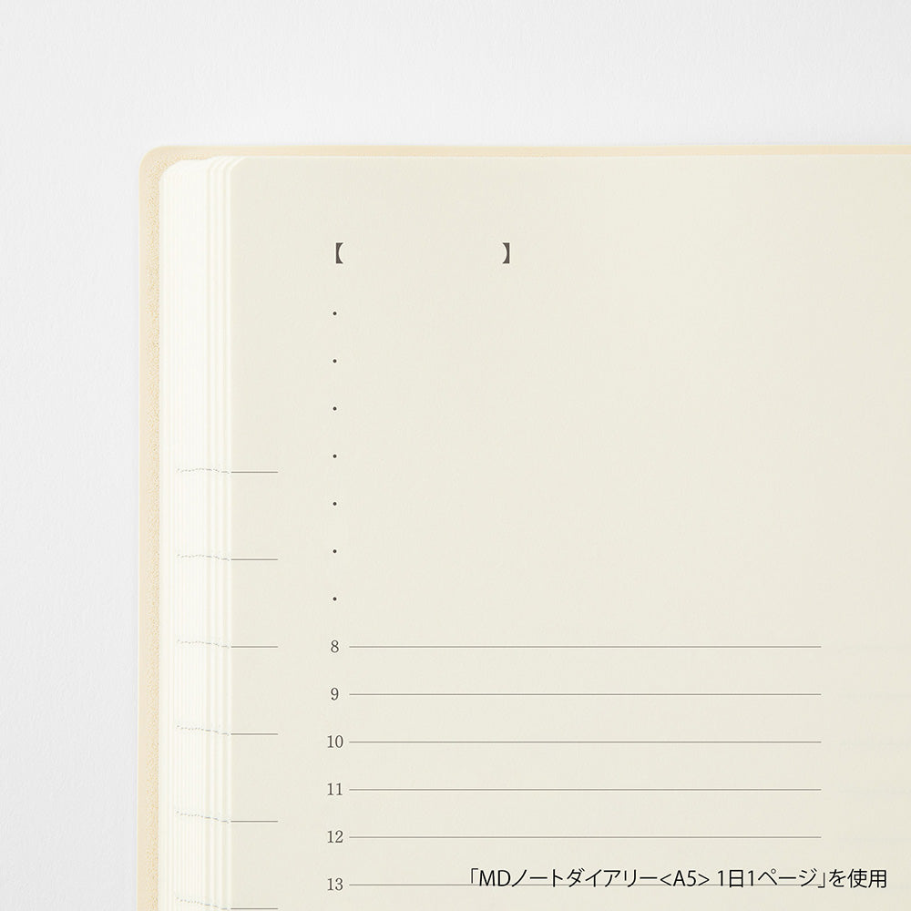 A close-up of a cream-colored daily journal page with black printed text and horizontal lines for writing, set against a clean white background.
