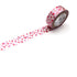 Roll of pink dotted patterned tape with a trail on a white background
