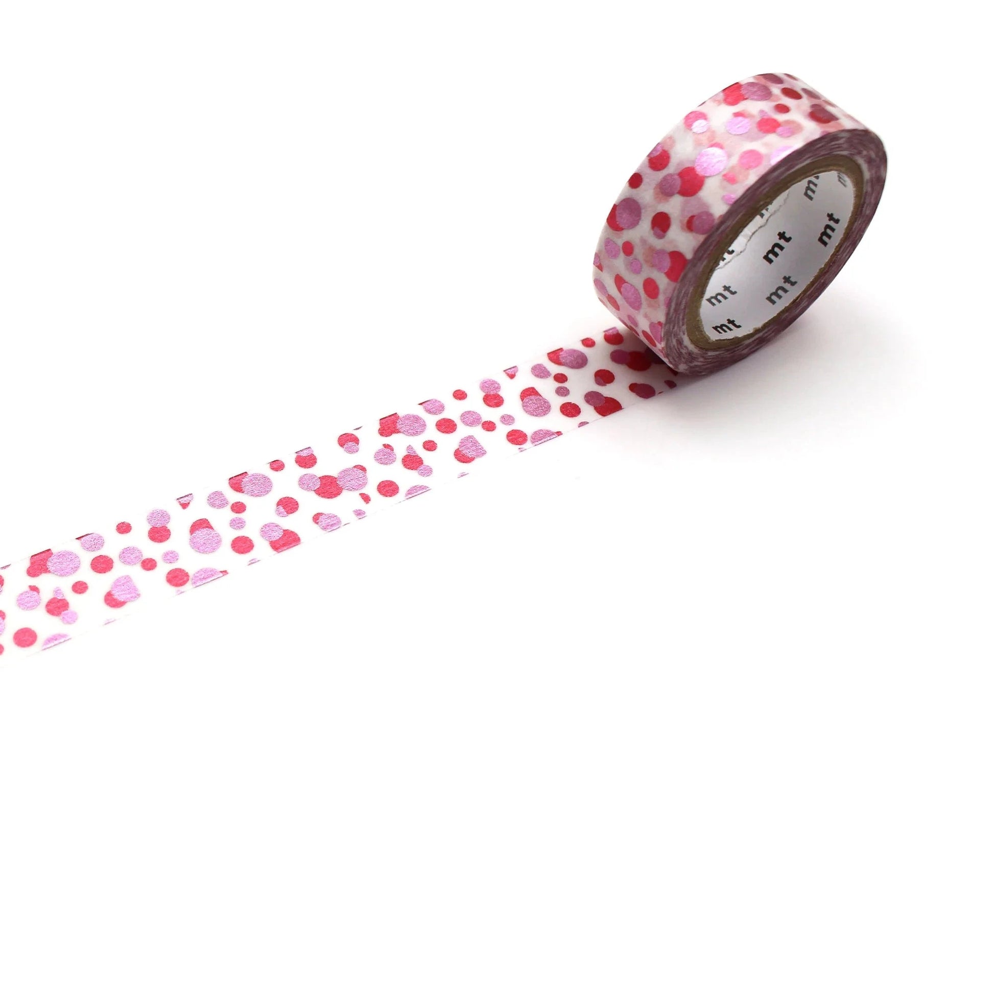 Roll of pink dotted patterned tape with a trail on a white background