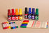 Set of colorful markers and pens on a beige background