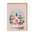 Christmas card with a snow globe design featuring a village scene and 'Merry Christmas' text on a pink background.