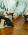 Metal Gadget Stand holding Nintendo Switch while two players play