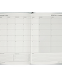 Open monthly planner with grid layout on white background