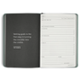 Open planner with a quote on the left page and a goal-setting layout on the right.