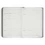 Open planner with checklists and notes on a white background