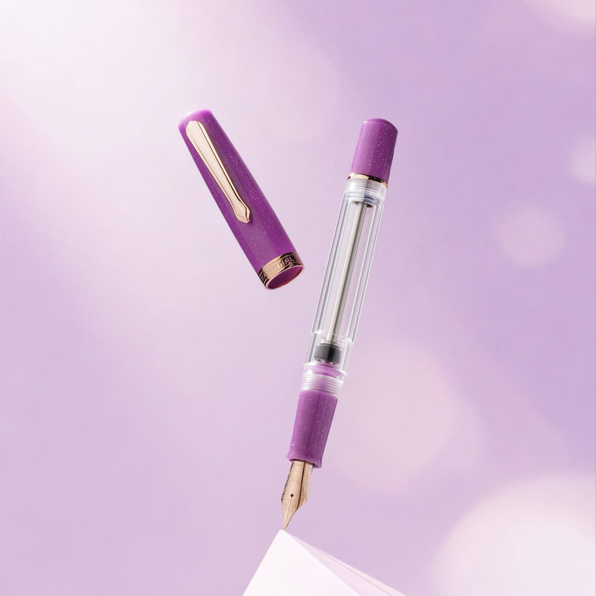 Purple fountain pen on a light purple background
