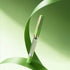 A green fountain pen with a clear barrel and rose gold accents, resting on a stylized green ribbon against a soft green gradient background.