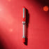 Red pen with a clear cartridge on a red background