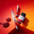 Red fountain pen and ink bottle on a red and orange gradient background