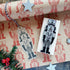 Wooden nutcracker stamp and matching tag on a decorative paper background