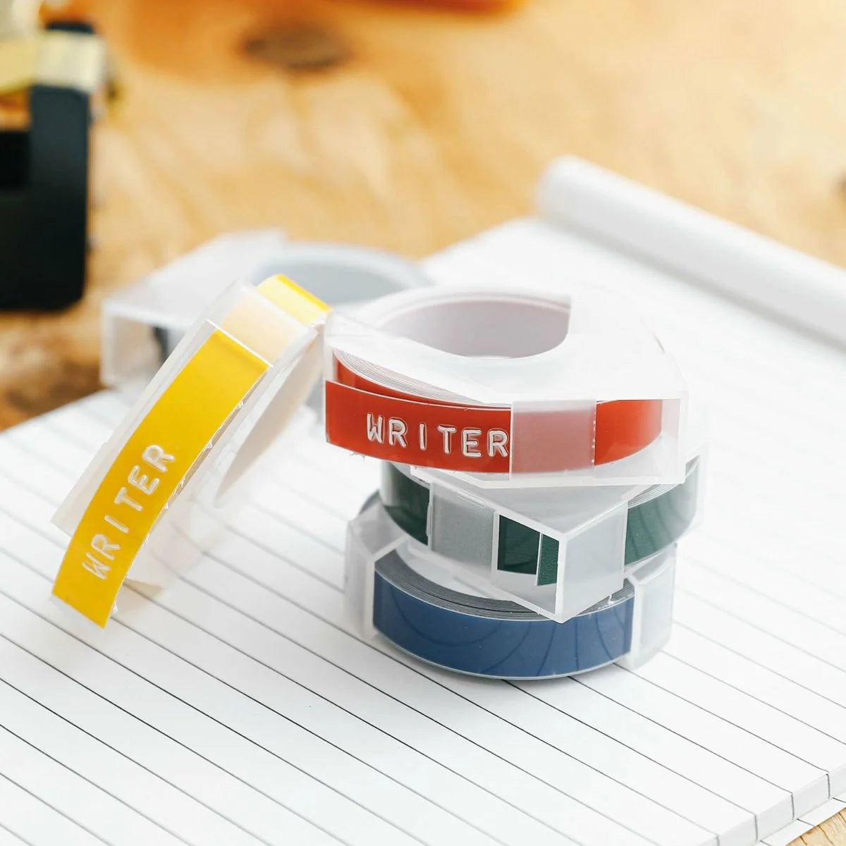 Set of colorful washi tape rolls on a notebook with 'WRITER' branding.