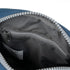 Close-up of a blue and gray bag with a zipper, showing the interior.