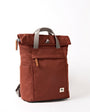 Brown backpack with gray straps on a white background