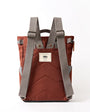 Brown backpack with gray straps on a white background