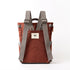 Brown backpack with gray straps on a white background