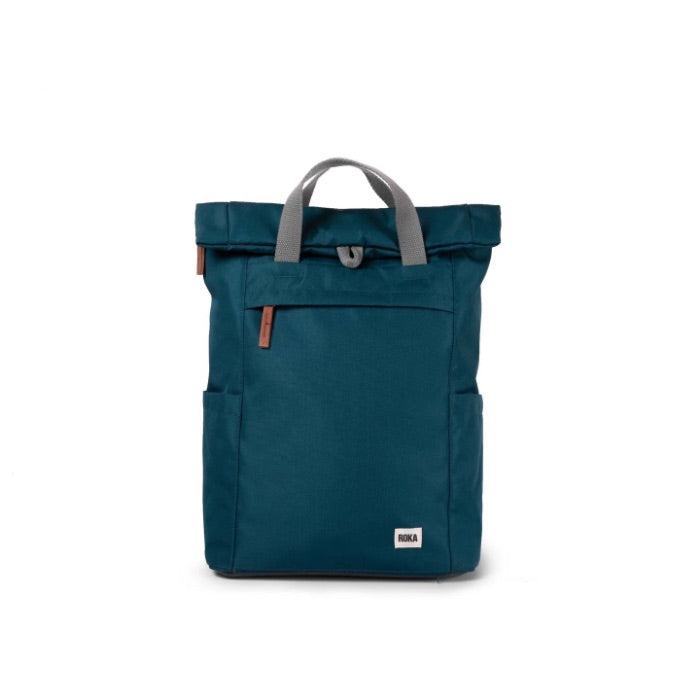 A medium-sized teal ROKA Finchley backpack with a roll-top closure, a large front pocket with zip, and two side handles.