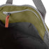 interior of moss coloured backpack in front of a white background