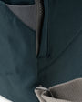 strap close up of dark grey coloured backpack on a white background