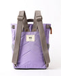 lavender coloured backpack on a white background with grey straps showing