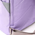close up shot of lavender coloured backpack showing straps on a white background