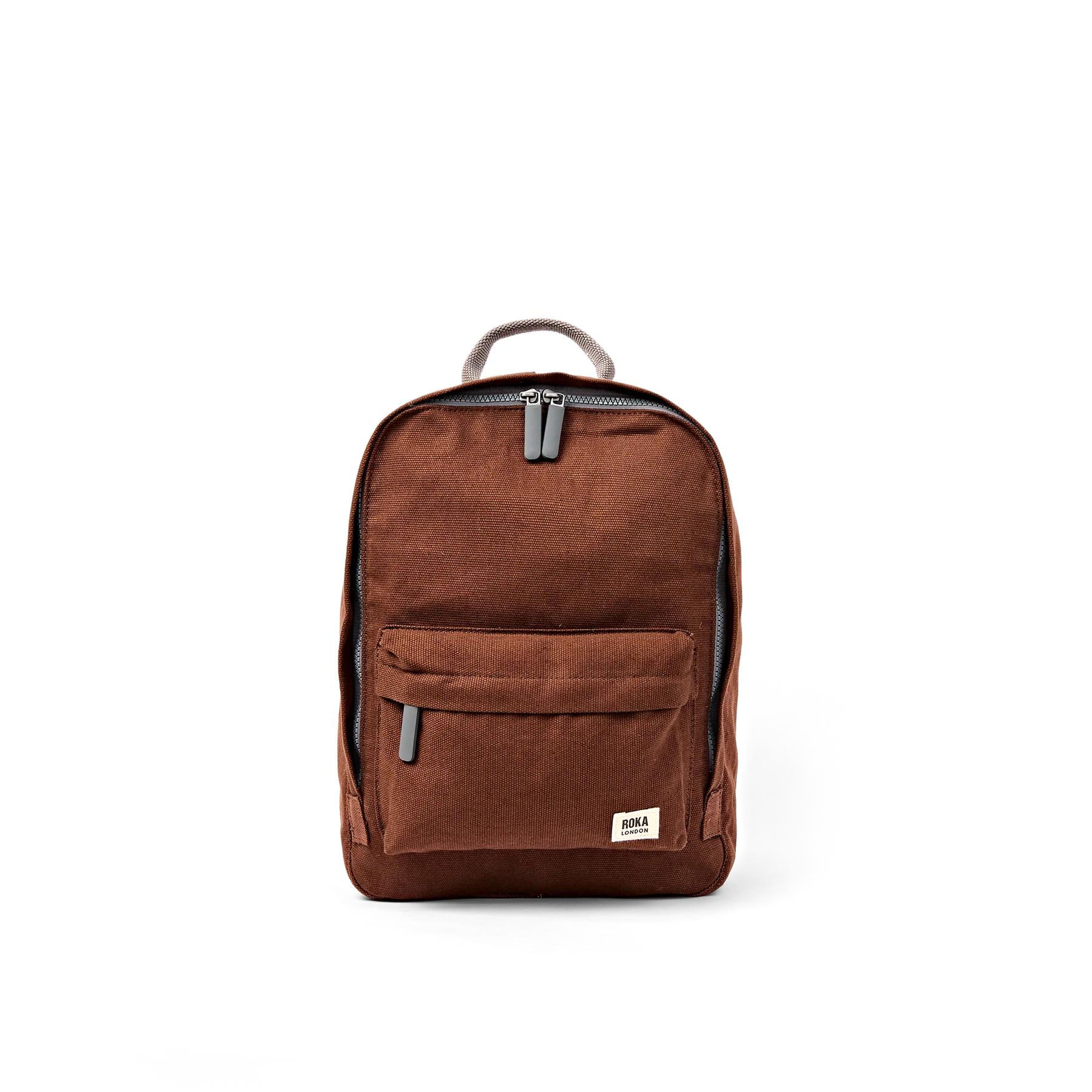 A brown canvas backpack with a front zippered pocket and a small rectangular brand patch on the lower right corner, shown against a plain white background.