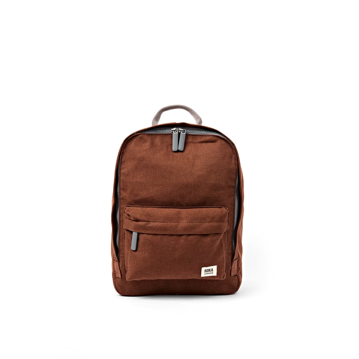 A brown canvas backpack with a front zippered pocket and a small rectangular brand patch on the lower right corner, shown against a plain white background.