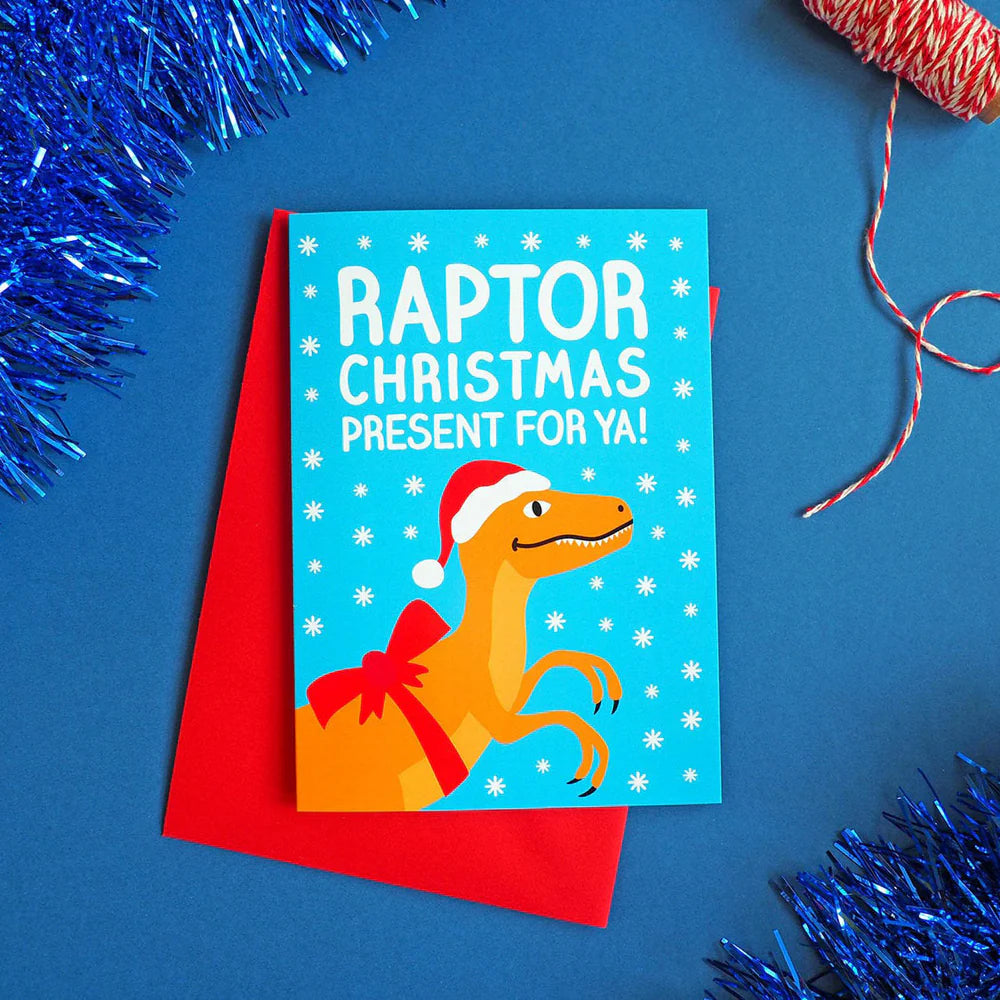 Christmas card with raptor illustration on a blue background