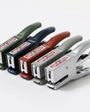 Set of staplers in various colors on a white background