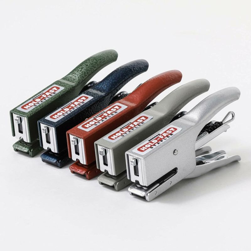 Set of staplers in various colors on a white background