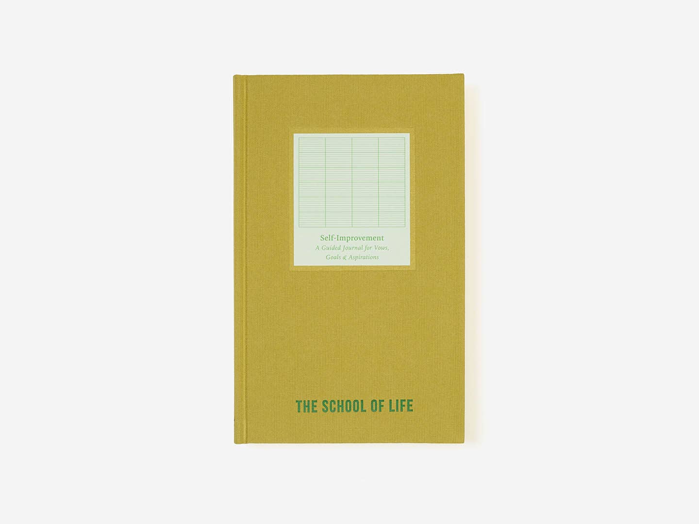 Yellow notebook with grid pattern and 'The School of Life' branding on a white background