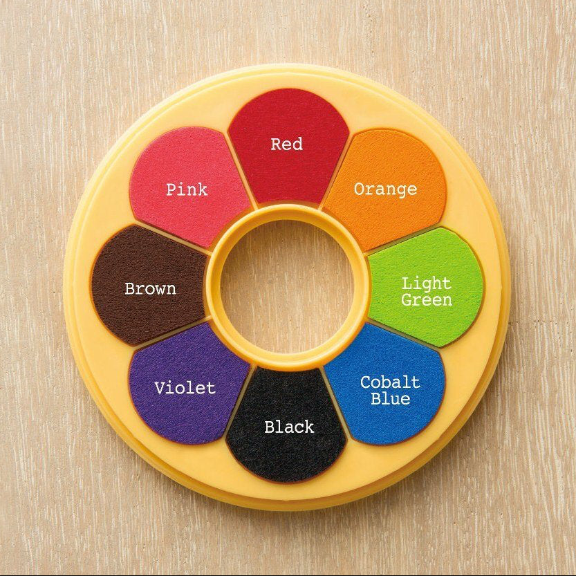 Color wheel with labeled colors on a wooden surface