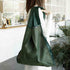 Person holding a green reusable bag in a kitchen setting