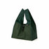 Green reusable shopping bag with mesh side on a white background