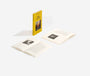 Two open books with black and white images on a white background