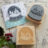 Wooden and rubber stamp with a winter scene design on a rustic wooden surface.