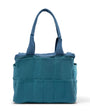 Blue tote bag with multiple pockets on a white background