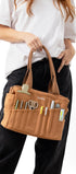 Person holding a brown tool bag with various tools on a white background