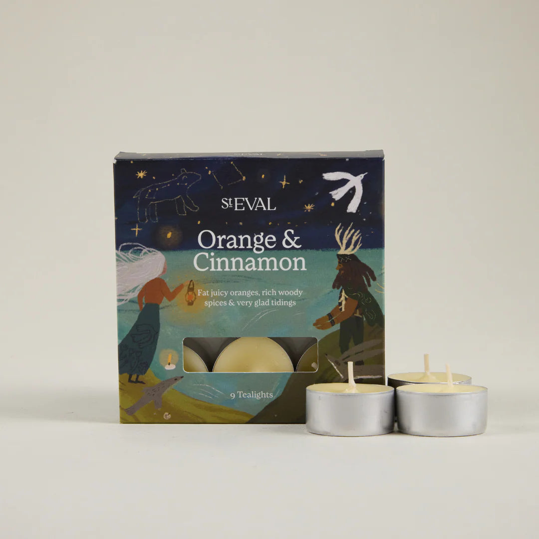 St Eval Orange & Cinnamon tea light candles with packaging on a neutral background